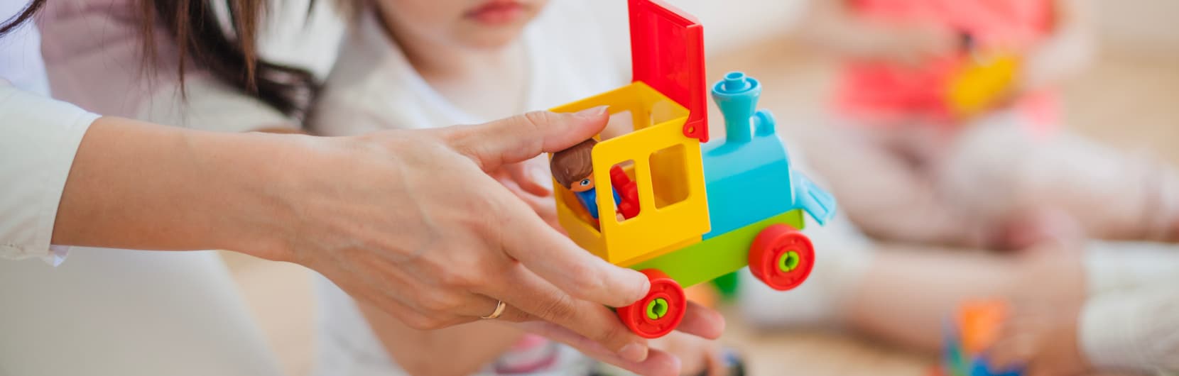 A hand holding a toy