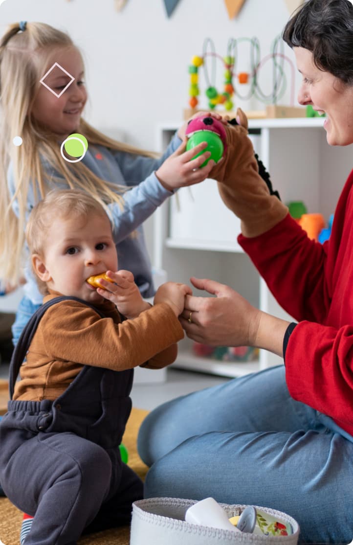 Children playing with a teacher