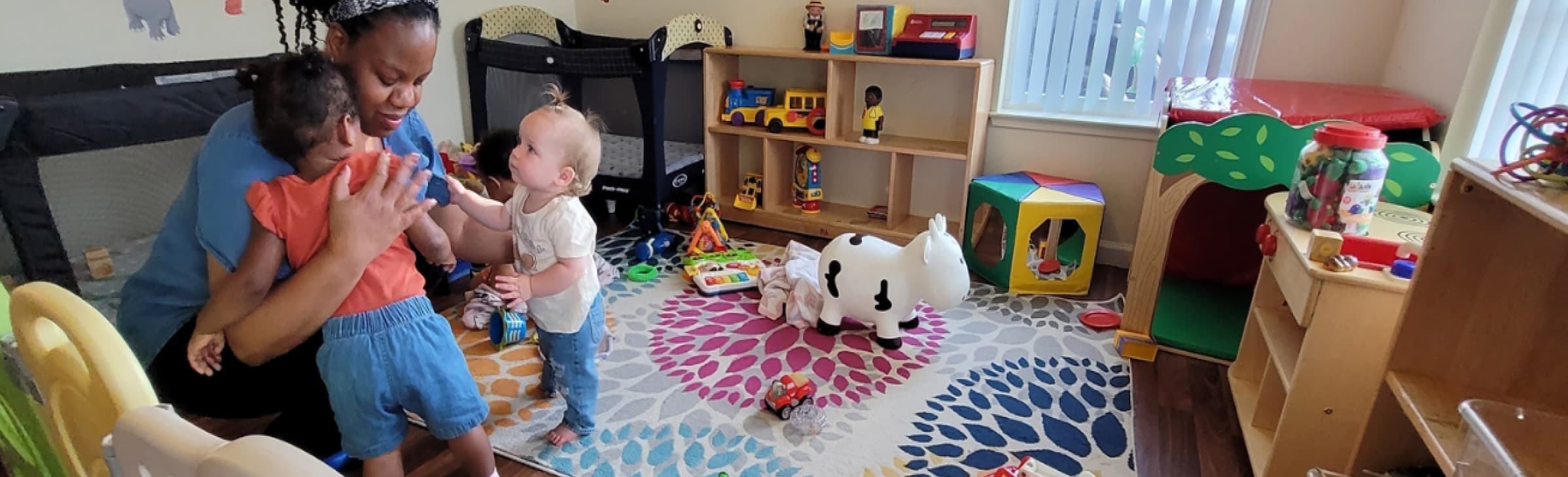 A caregiver holding children